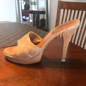 Tan leather with handmade stitch designs.